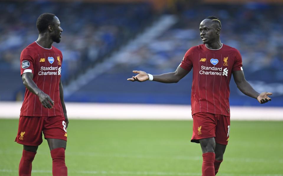 Liverpool's Naby Keita, left, and Liverpool's Sadio Mane discuss as they leave the pitch at half time during the English Premier League soccer match between Everton and Liverpool at Goodison Park in Liverpool, England, Sunday, June 21, 2020. (Peter Powell/Pool via AP)