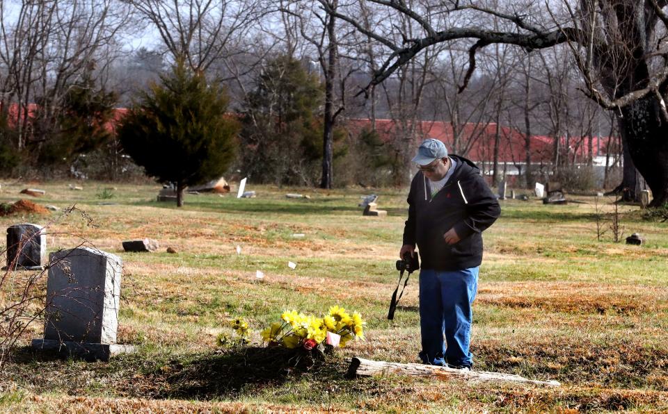 Vice President Billy McKinley of the African American Heritage Society of Rutherford County explores and takes photographs of some of the grave markers in the Benevolent Cemetery in Murfreesboro, Tenn., on Tuesday, Jan. 25, 2022.