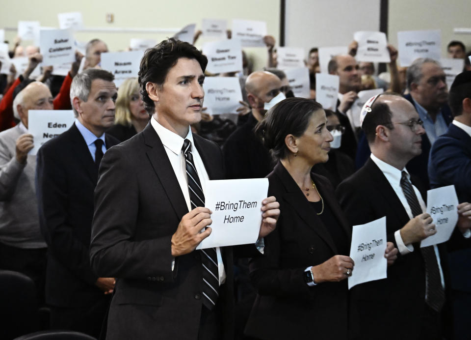 Prime Minister Justin Trudeau holds a sign at a rally in support of Israel, at the Soloway Jewish Community Centre in Ottawa on Monday, October 9, 2023. THE CANADIAN PRESS/Justin Tang