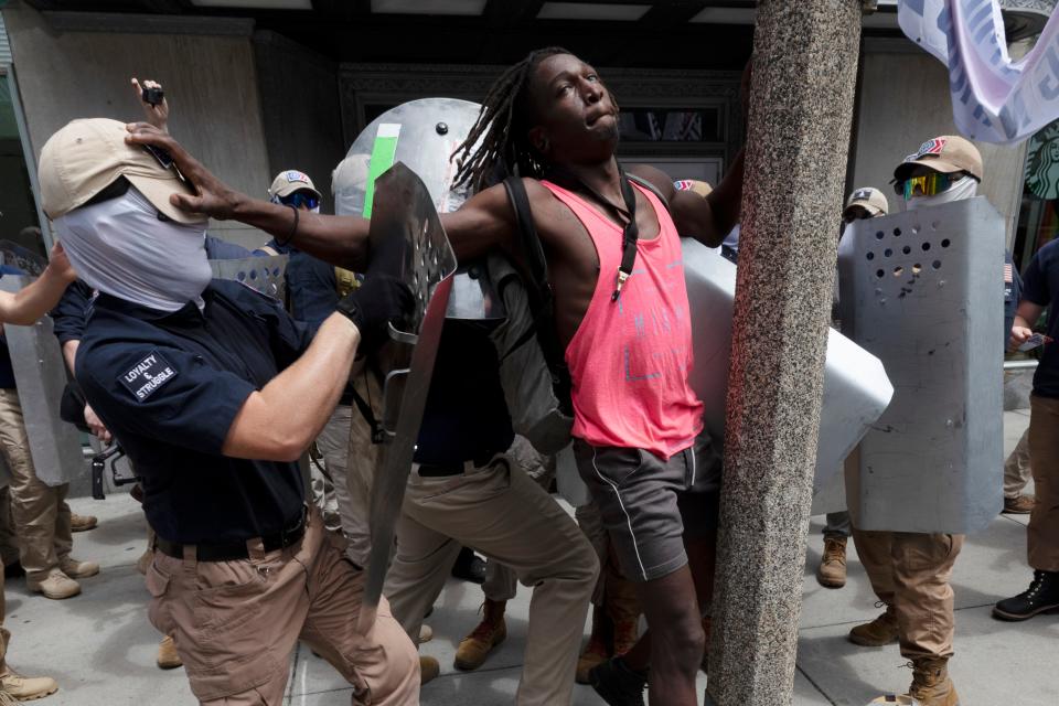 Charles Murrell, center, fends off a marcher from a group bearing insignias of the white supremacist group Patriot Front on July 2, 2022, in Boston. Murrell alleges the group punched, kicked and beat him with metal shields during a march through Boston in 2022.