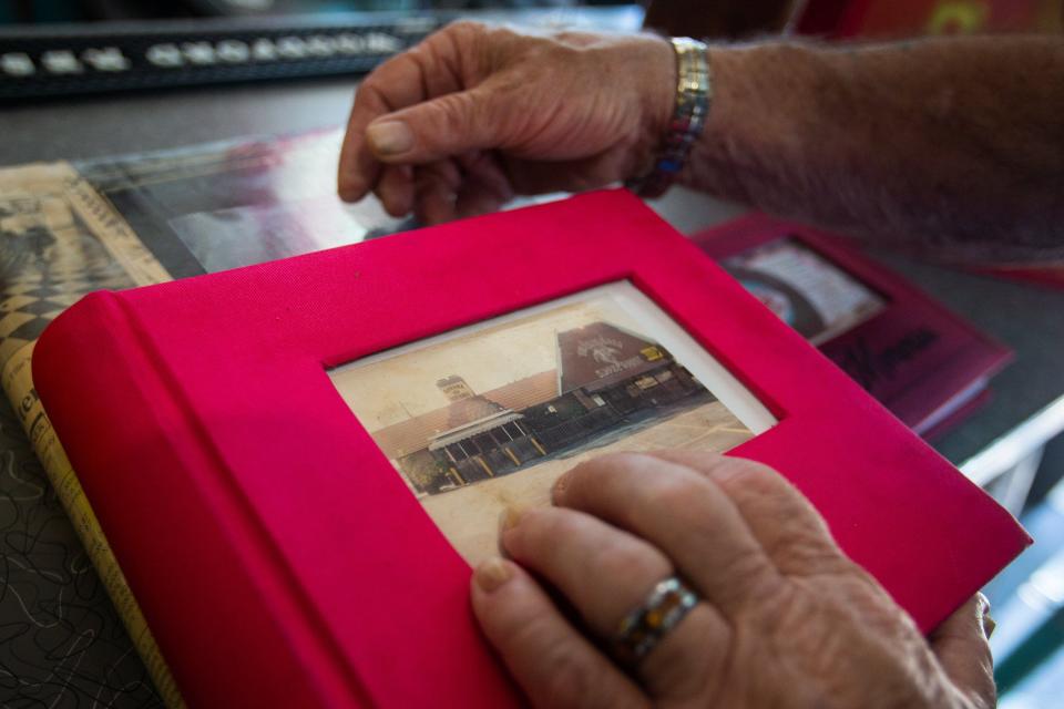 A new chapter awaits: Ellie's 50's Diner co-owner Bob Smela rests a hand on an album that recounts the diner's years. On the cover is a photo of the former Bahama Smokehouse, which would be replaced by Ellie's.