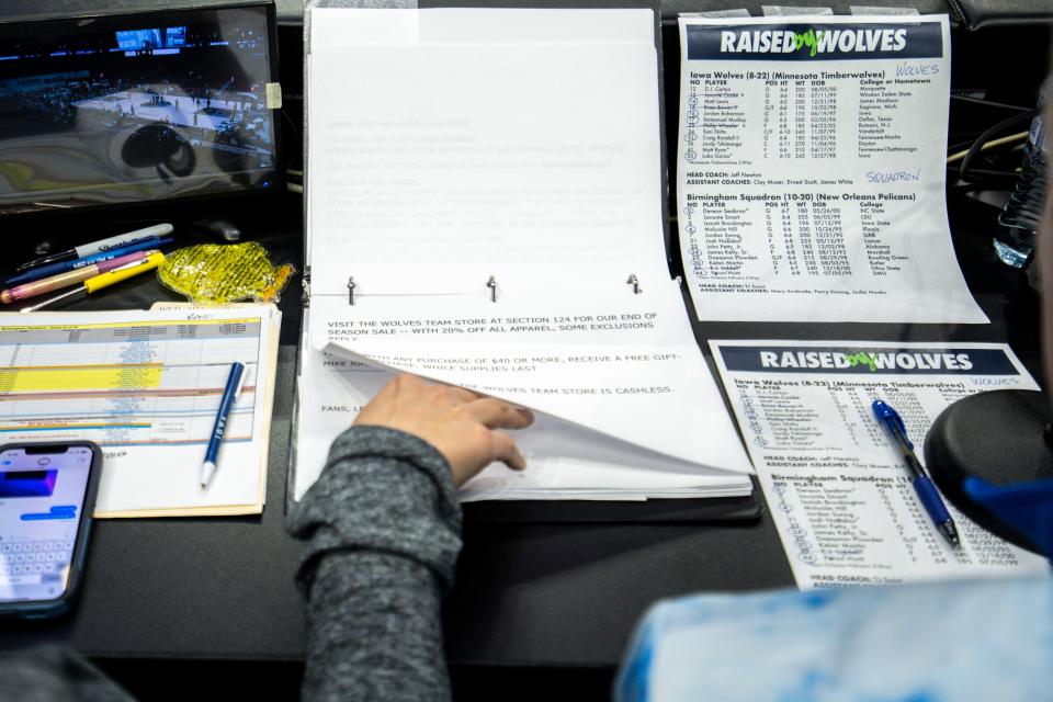 Randi Burrell, Iowa Wolves vice president of operations, flips the public-address announcer's script before Wednesday's game at Wells Fargo Arena in Des Moines.