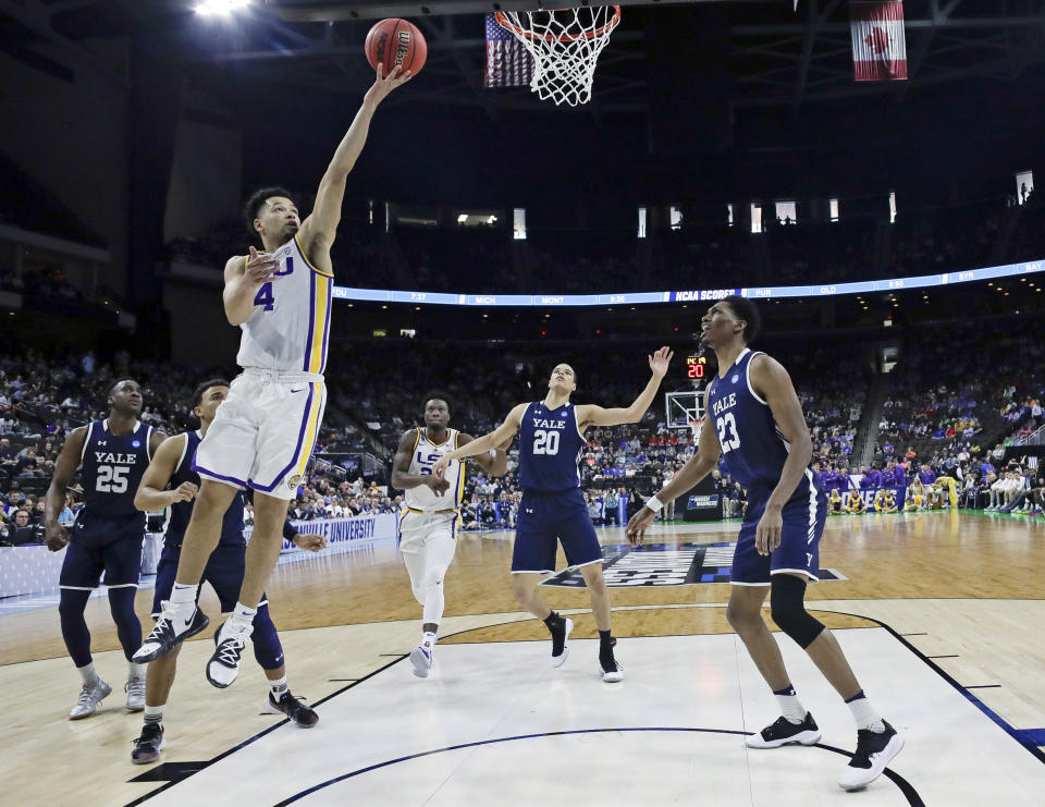 LSU's Skylar Mays (4) goes up for a shot over Yale 's Paul Atkinson (20) and Jordan Bruner (23) during the first half of a first round men's college basketball game in the NCAA Tournament in Jacksonville, Fla., Thursday, March 21, 2019. (AP Photo/John Raoux)