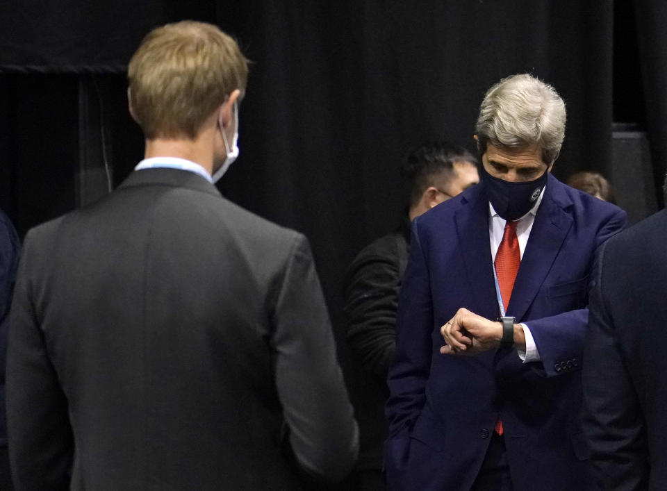 John Kerry, United States Special Presidential Envoy for Climate looks at his watch during the COP26 U.N. Climate Summit in Glasgow, Scotland, Tuesday, Nov. 9, 2021. The U.N. climate summit in Glasgow has entered it's second week as leaders from around the world, are gathering in Scotland's biggest city, to lay out their vision for addressing the common challenge of global warming. (AP Photo/Alberto Pezzali)