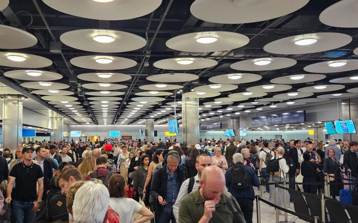 Long queues at the UK Border checkpoint, following a glitch in the electronic gate system, at London Heathrow Airport, in London
