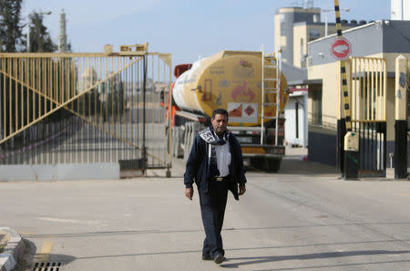 A man stands as a fuel tanker arrives at Gaza's power plant in the central Gaza Strip January 16, 2017. REUTERS/Ibraheem Abu Mustafa