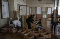 Workers and volunteers of the Andrey Sheptytsky National Museum store Baroque pieces in cardboard boxes as safety preparations in the event of an attack in the western Ukrainian city of Lviv, Friday, March 4, 2022. (AP Photo/Bernat Armangue)