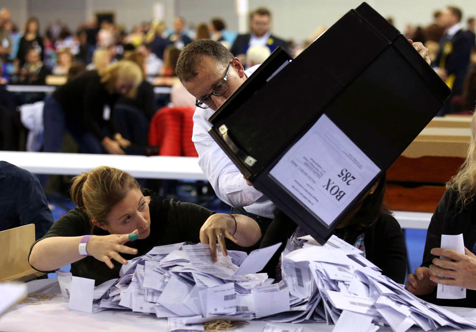 <p>Ballot boxes are emptied to be counted for the general election, at the Emirates Arena in Glasgow, Scotland, Thursday June 8, 2017. (Photo: Andrew Milligan/PA via AP) </p>