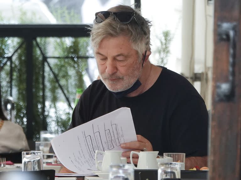 Photo © 2022 Mega/The Grosby Group

Alec Baldwin looks a little disheveled as he returns to work for the first time since a cinematographer was shot and killed on the set of his film Rust. The actor, 63, was spotted sitting outside a bar in Rome, reading the script from his new movie. He was later seen heading for a hair and make-up session, and returned looking a lot smarter. Baldwinis set to begin filming two Italian movies, Kid Santa and Billie's Magic World, according to Variety. The films are being produced by Alec and his brother Daniel Baldwin. Kid Santa and Billie's Magic World are both by Italian director Francesco Cinquemani, who previously worked with Alec on the 2015 film Andron. He also directed the 2021 film The Christmas Witch, which starred Alec's brother William Baldwin. The two films are being billed as 'live-action/animation family Christmas comedies', according to Variety. Alec has been dealing with an ongoing wrongful death lawsuit over the on-set shooting death of Hutchins. Cinematographer Halyna Hutchins, 42, died on October 21 last year when a prop gun used in the film Rust was fired by Alec after he was told it wasn't loaded, shooting her in the chest. Director Joel Souza was also injured from Baldwin's prop gun, though he survived his injuries. Earlier this month, lawyers for the film's armorer, Hannah Gutierrez, released a statement condemning the actor for pointing his firearm at crew members despite that being a violation of safety protocol. 28 Mar 2022