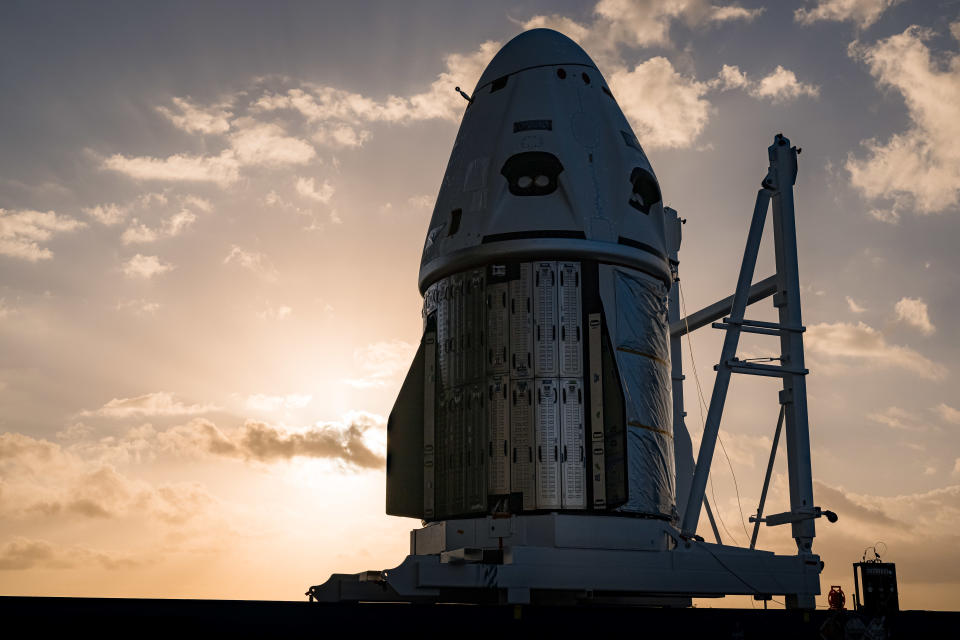 spacecraft on a launch pad in front of sunrise