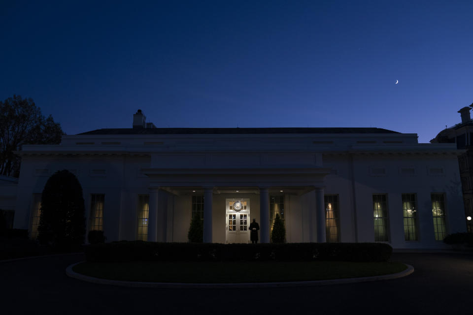 A Marine stands outside the entrance to the West Wing of the White House, signifying that President Donald Trump is in the Oval Office, Wednesday, Nov. 18, 2020, in Washington. (AP Photo/Evan Vucci)