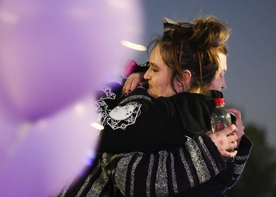 Cassie Matthews is comforted after speaking at a vigil in honor of her 11-year-old daughter, Audrii Cunningham, Wednesday, Feb. 21, 2024, in Livingston, Texas. Cunningham's family reported her missing Thursday, Feb. 15, when she failed to return to her Livingston home after school. On Tuesday, Feb. 20, search teams found her body in the Trinity River in a rural area north of Houston about 10 miles (16 kilometers) from her home, according to the capital murder criminal complaint filed Tuesday against Don Steven McDougal, a family friend accused of killing the young girl. (Jason Fochtman/Houston Chronicle via AP)