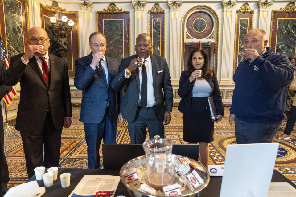 Members of the President's Council on Sports, Fitness and Nutrition, from left, Rep. Jim McGovern, D-Mass., second gentleman Doug Emhoff, White House Office of Public Engagement Director Stephen Benjamin, White House Domestic Policy Advisor Neera Tanden, and chef Jose Andres, try some reduced sugar chocolate milk at an exhibit about milk in schools before attending an event about ending hunger in America, Tuesday, Feb. 27, 2024, at the Eisenhower Executive Office Building on the White House complex in Washington. (AP Photo/Jacquelyn Martin)