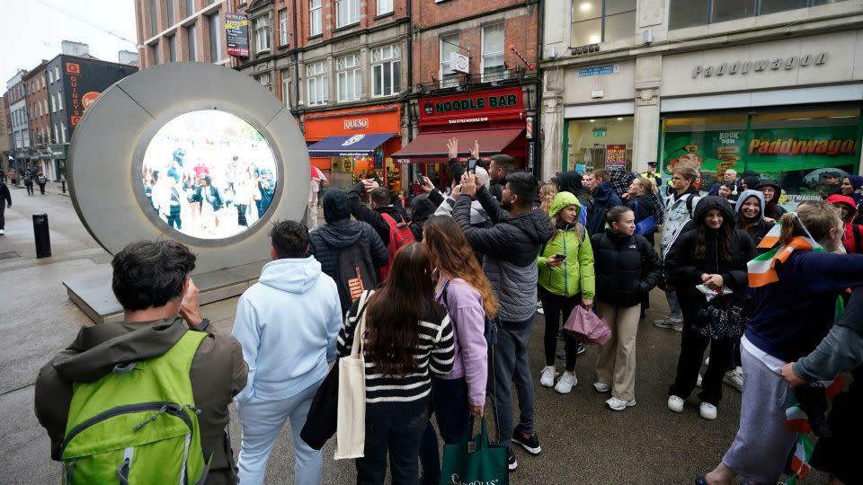 People view the live stream between Dublin and New York, in Dublin, Ireland, on May 13. - Niall Carson/PA via AP