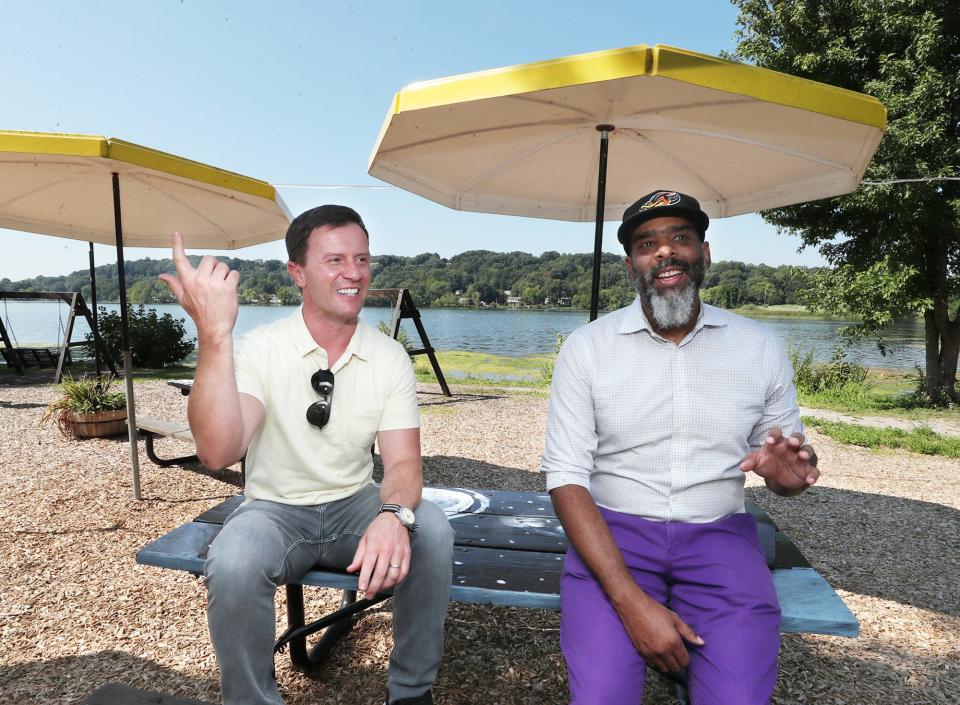 Kyle Kutuchief of the Knight Foundation, left, and Roger Riddle talk about the Akron Civic Commons Summit Lake Postcard Project at Summit Lake in Akron.