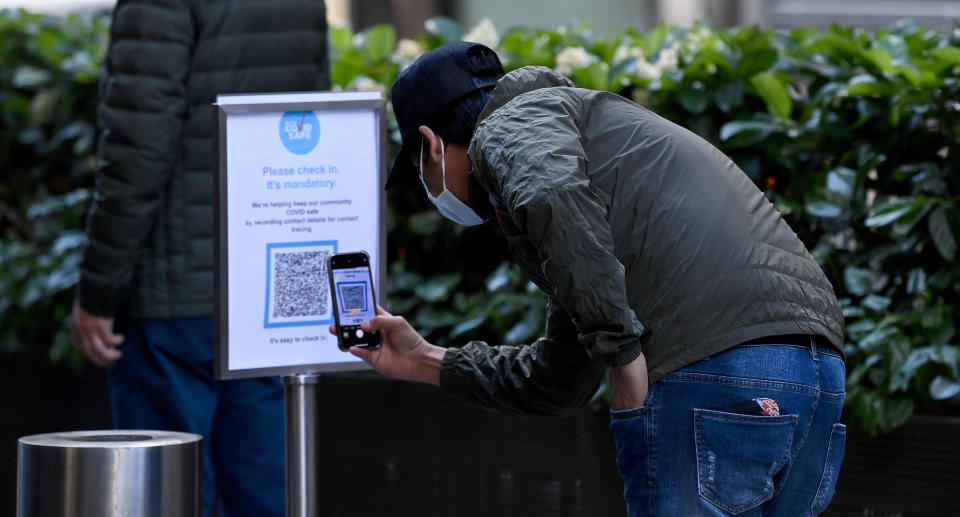 Members of the public wear face masks as they check into the Sonic Healthcare COVID-19 Vaccinations hub in the central business district (CBD) of Sydney, Thursday, September 23, 2021. Source: AAP