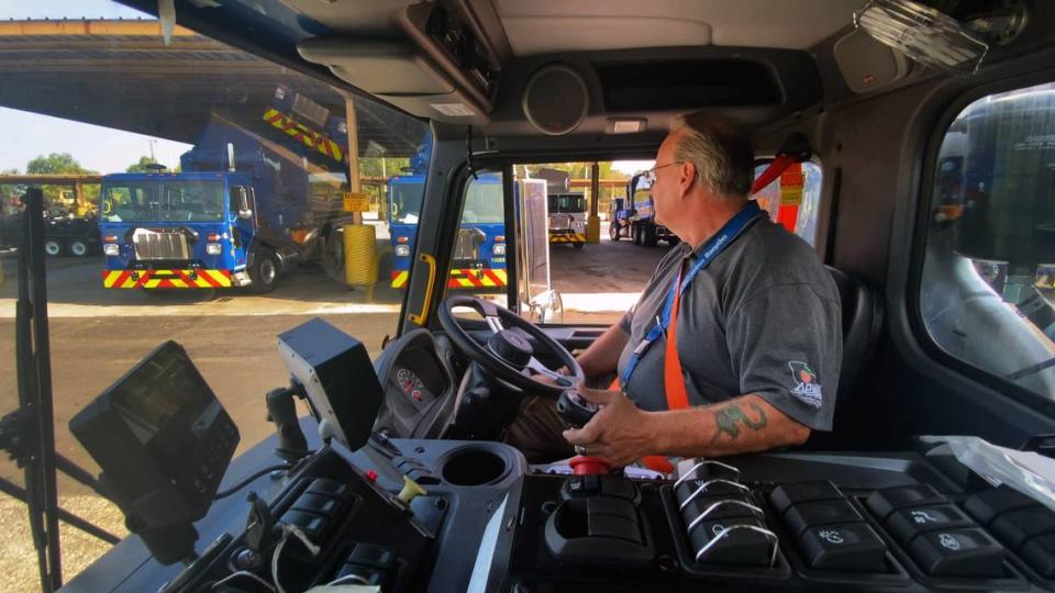 James Mang, the interim division manager of solid waste collections for the Columbus Consolidated Government, demonstrates how how oone of the city’s new “Columbus Blue” automated side loaders works. 09/07/2023