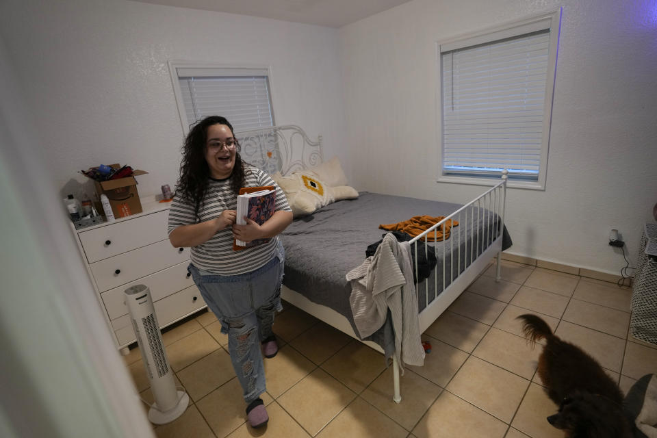 Krystal Guerra, 32, walks inside the apartment which she is packing up to leave, after her new landlord gave her less than a month's notice that her rent would go up by 26%, Saturday, Feb. 12, 2022, in the Coral Way neighborhood of Miami. Guerra, who works in marketing while also pursuing a degree part-time, had already been spending nearly 50% of her monthly income on rent prior to the increase. Unable to afford a comparable apartment in the area as rents throughout the city have risen dramatically, Guerra is putting many of her belongings into storage and moving in with her boyfriend and his daughter for the time being. (AP Photo/Rebecca Blackwell)