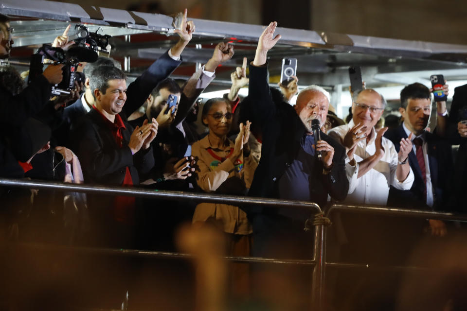 Former Brazilian President Luiz Inacio Lula da Silva, right, who is running for president again, speaks to supporters after general election polls closed in Sao Paulo, Brazil, Sunday, Oct. 2, 2022.(AP Photo/Marcelo Chello)