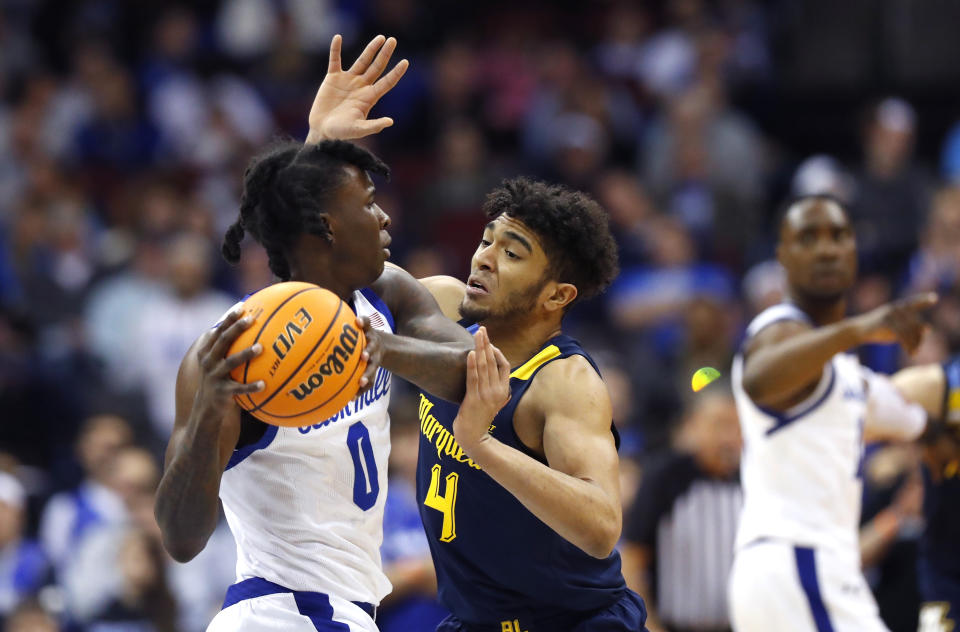 Marquette guard Stevie Mitchell (4) defends against Seton Hall guard Kadary Richmond (0) during the first half of an NCAA college basketball game in Newark, N.J., Saturday, Jan. 21, 2023. (AP Photo/Noah K. Murray)