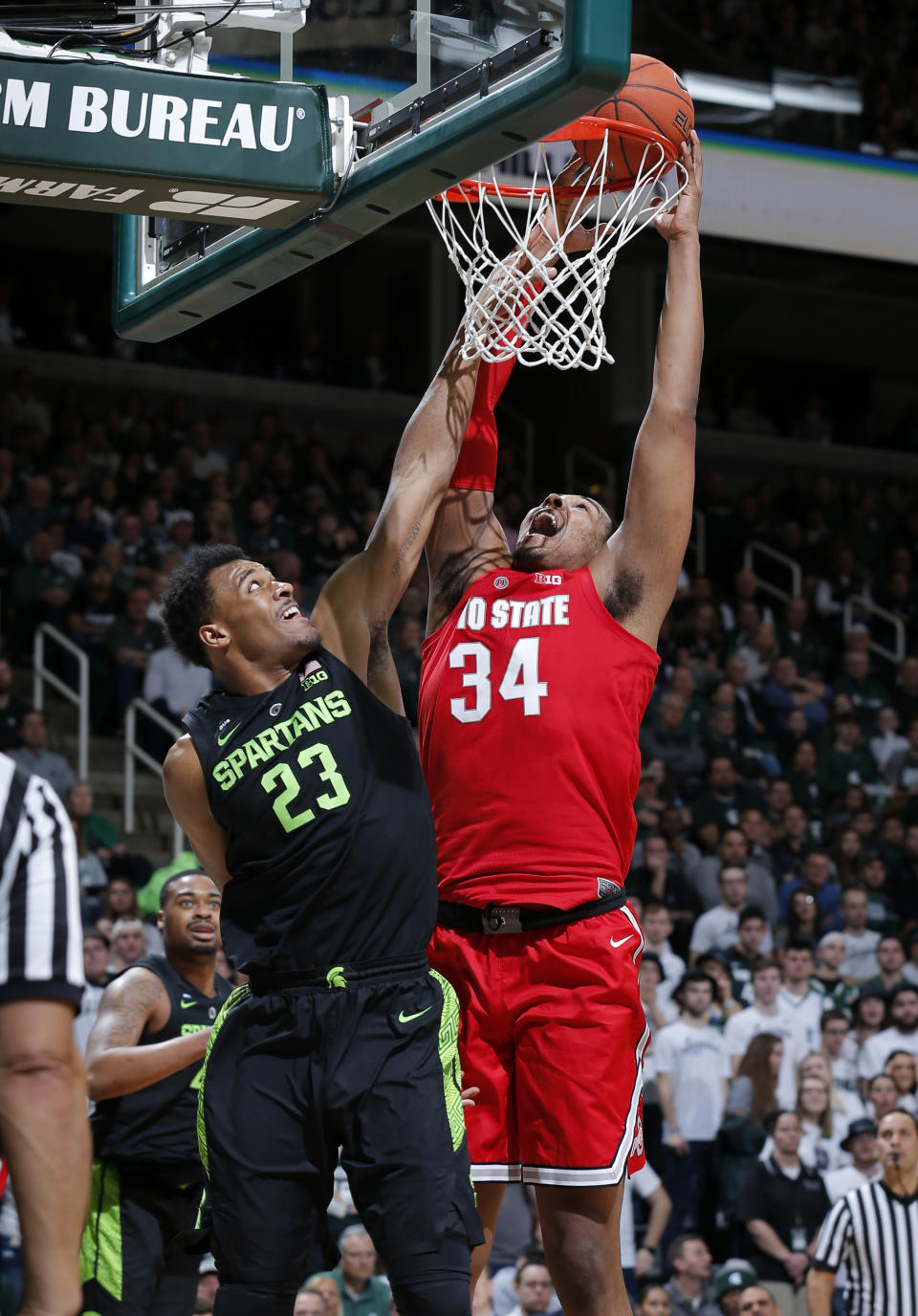 Ohio State's Kaleb Wesson, right, shoots and draws a foul against Michigan State's Xavier Tillman (23) during the first half of an NCAA college basketball game, Sunday, Feb. 17, 2019, in East Lansing, Mich. (AP Photo/Al Goldis)