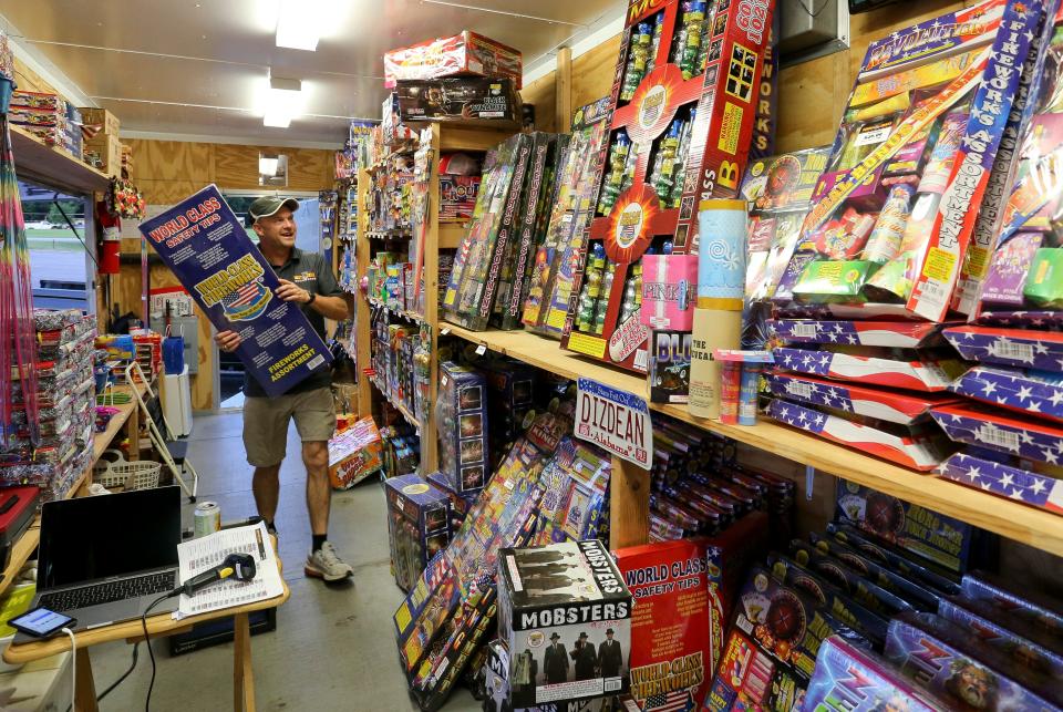 Glenn Dodd stocks his Dizzy Dean's Fireworks stand on Alabama Highway 69 north in Northport on June 29, 2020. [Staff Photo/Gary Cosby Jr.]