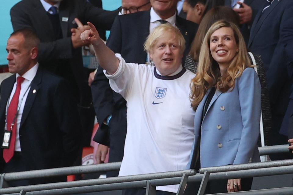 UK Prime Minister Boris Johnson and his spouse Carrie (R), are pictured ahead of the UEFA EURO 2020 semi-final football match between England and Denmark at Wembley Stadium in London on July 7, 2021. (Photo by CARL RECINE / POOL / AFP) (Photo by CARL RECINE/POOL/AFP via Getty Images)