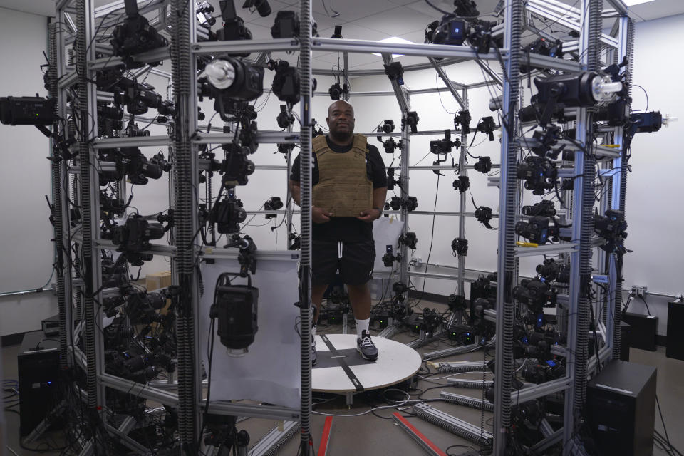 FILE - A man wears a bulletproof vest that is mapped in a photogrammetry room for the video game series Call of Duty on Oct. 21, 2022, at Activision Blizzard, Infinity Ward Division, in Woodland Hills, Calif. Microsoft’s purchase of video game maker Activision Blizzard won final approval Friday, Oct. 13, from Britain’s competition watchdog, reversing its earlier decision to block the $69 billion deal and removing a last obstacle for one of the largest tech transactions in history. (AP Photo/Allison Dinner, File)