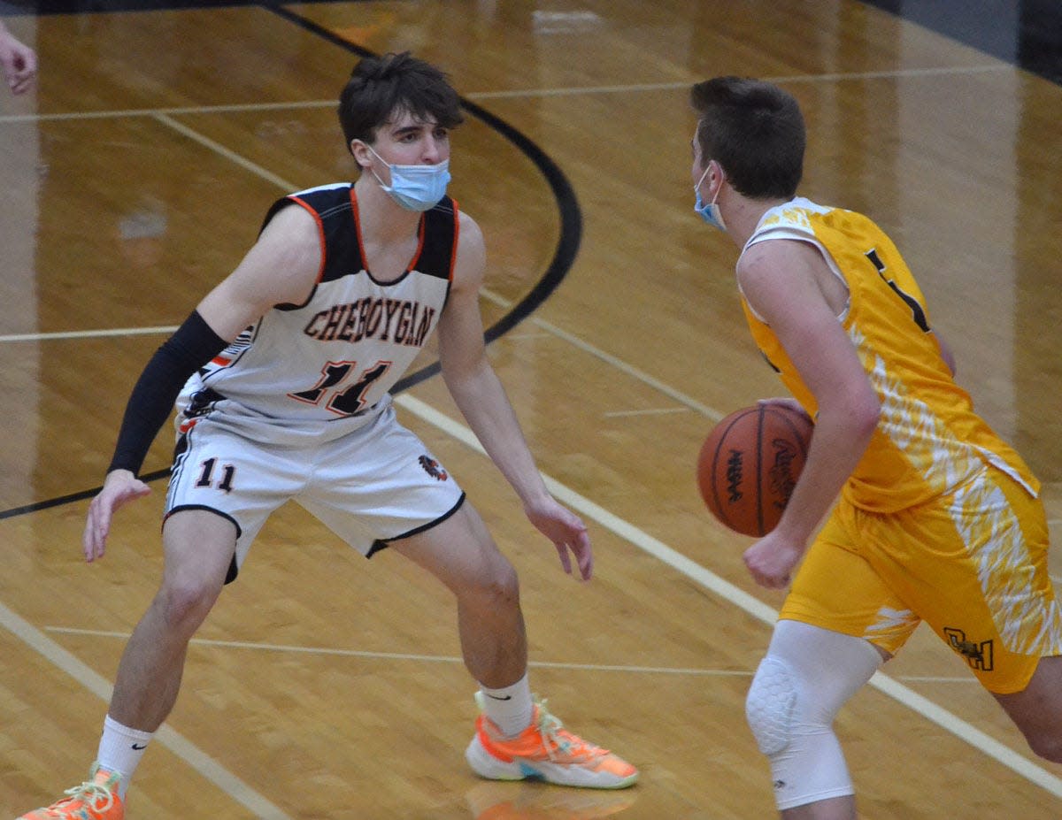 Cheboygan's David Heyer, left, defends an Ogemaw Heights player during a boys basketball game from last season. Heyer was one of three Chiefs to reach double figures in points in a season-opening 56-30 victory at Rogers City on Tuesday.