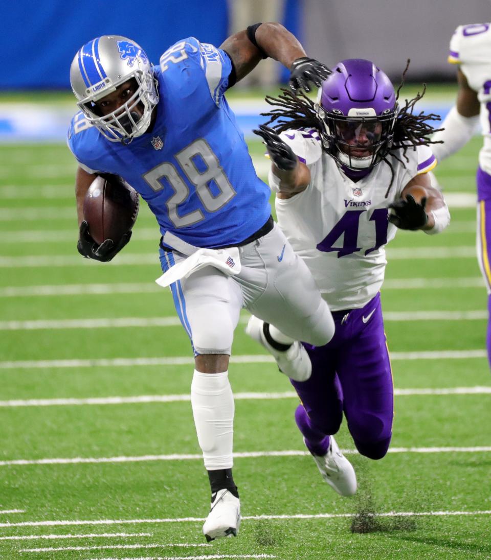 Adrian Peterson is pushed out of bounds by Vikings safety Anthony Harris at Ford Field, Jan. 3, 2021.