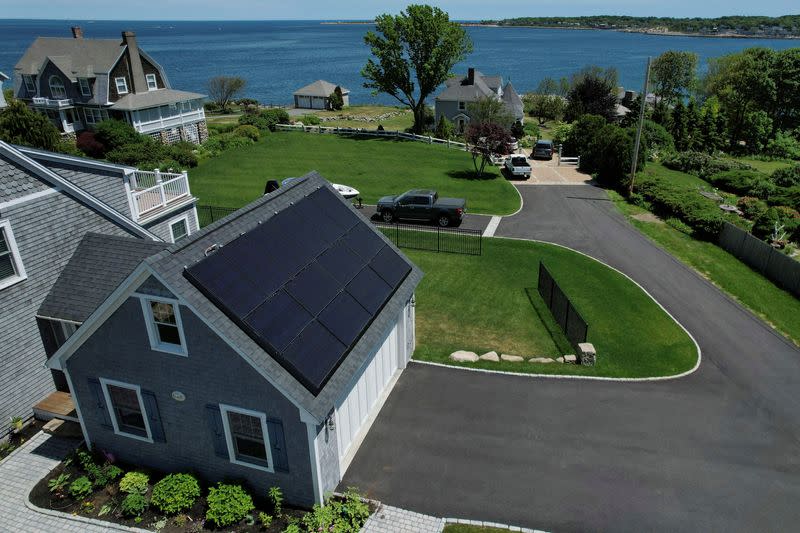 FILE PHOTO: Solar panels create electricity on the roof of a house in Rockport