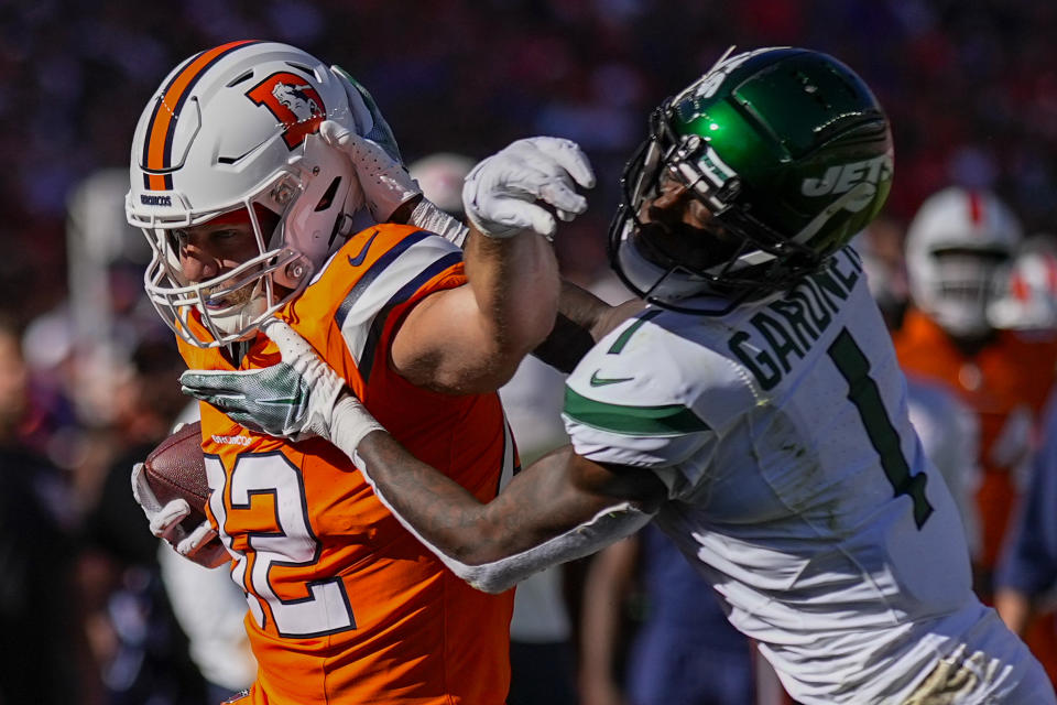 Denver Broncos tight end Adam Trautman is pushed out of bounds by New York Jets cornerback Sauce Gardner during the first half of an NFL football game Sunday, Oct. 8, 2023, in Denver. (AP Photo/Jack Dempsey)