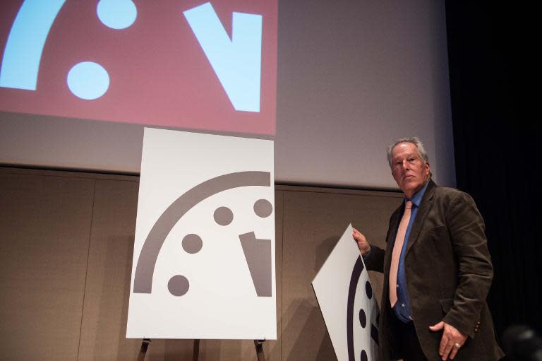 Professor Richard Somerville of UC San Diego unveils the "Doomsday Clock", showing that the world is now three minutes away from nuclear disaster, during a press conference of the Bulletin of Atomic Scientistists in Washington on January 22, 2015