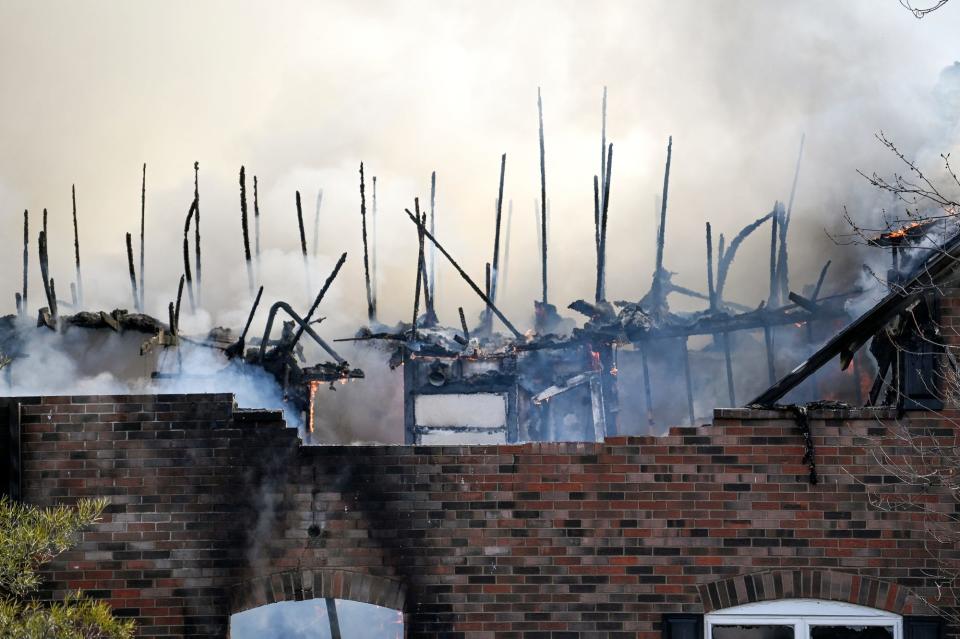 The roof of a portion of at Knob Hill Apartments building is completely burned off on Wednesday, Dec. 21, 2022, in Okemos.