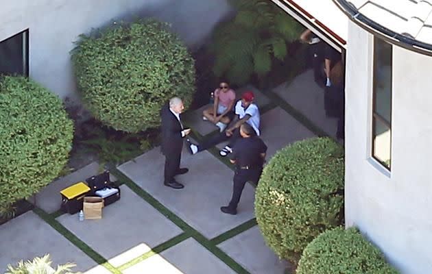 Chris Brown with the police outside his house. Source: Splash News