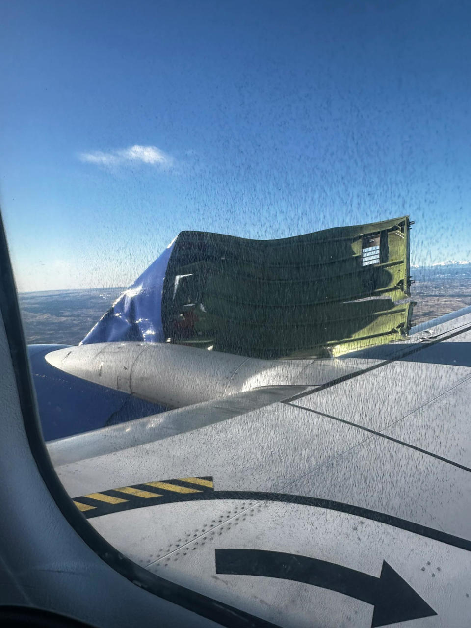 The engine cowling hanging from the wing of a Southwest Airlines flight (Cooper Glass)