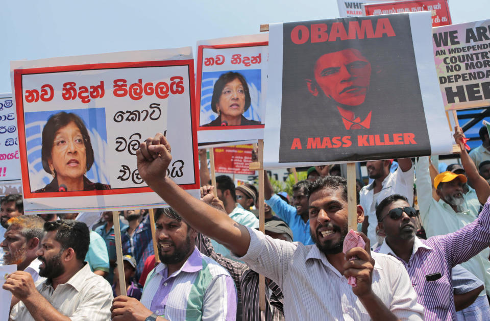 FILE - In this March 26, 2014 file photo Sri Lankan government supporters shout slogans against the U.S. and U.N. during a demonstration in Colombo, Sri Lanka. The U.N.'s top human rights body has approved Thursday, March 27, 2014, an international criminal investigation into alleged abuses in Sri Lanka's civil war, which ended in 2009. Members of the 47-nation U.N. Human Rights Council have agreed to set up the yearlong investigation, estimated to cost US dollar 1.46 million, based on the recommendation of U.N. High Commissioner for Human Rights Navi Pillay. Placard carrying a portrait of Pillay reads "Navi Pillay hangs on to tiger tail." (AP Photo/Eranga Jayawardena, File)