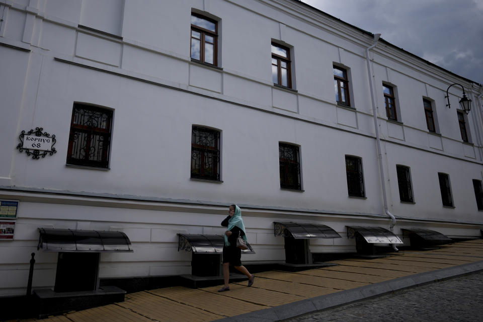 FILE - A woman walks outside the Kyiv Pechersk Lavra Monastery in Kyiv, Ukraine, Saturday, May 28, 2022. Ukraine’s counter-intelligence service, police and the country's National Guard on Tuesday, Nov. 22, 2022 searched the Pechersk Lavra monastic complex, one of the most famous Orthodox Christian sites in the capital, Kyiv, after a priest spoke favorably about Russia – Ukraine’s invader – during a service there. (AP Photo/Natacha Pisarenko, File)