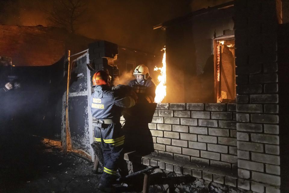 Firefighters extinguish a fire after a Russian attack on a residential neighborhood in Kharkiv, Ukraine Saturday, Feb. 10, 2024. (AP Photo/Yevhen Titov)