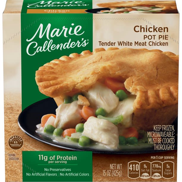 Box of Marie DCallender's with chicken pot pie sliced open to reveal soupy chicken, carrots, and peas spilling out of a crusty shell.