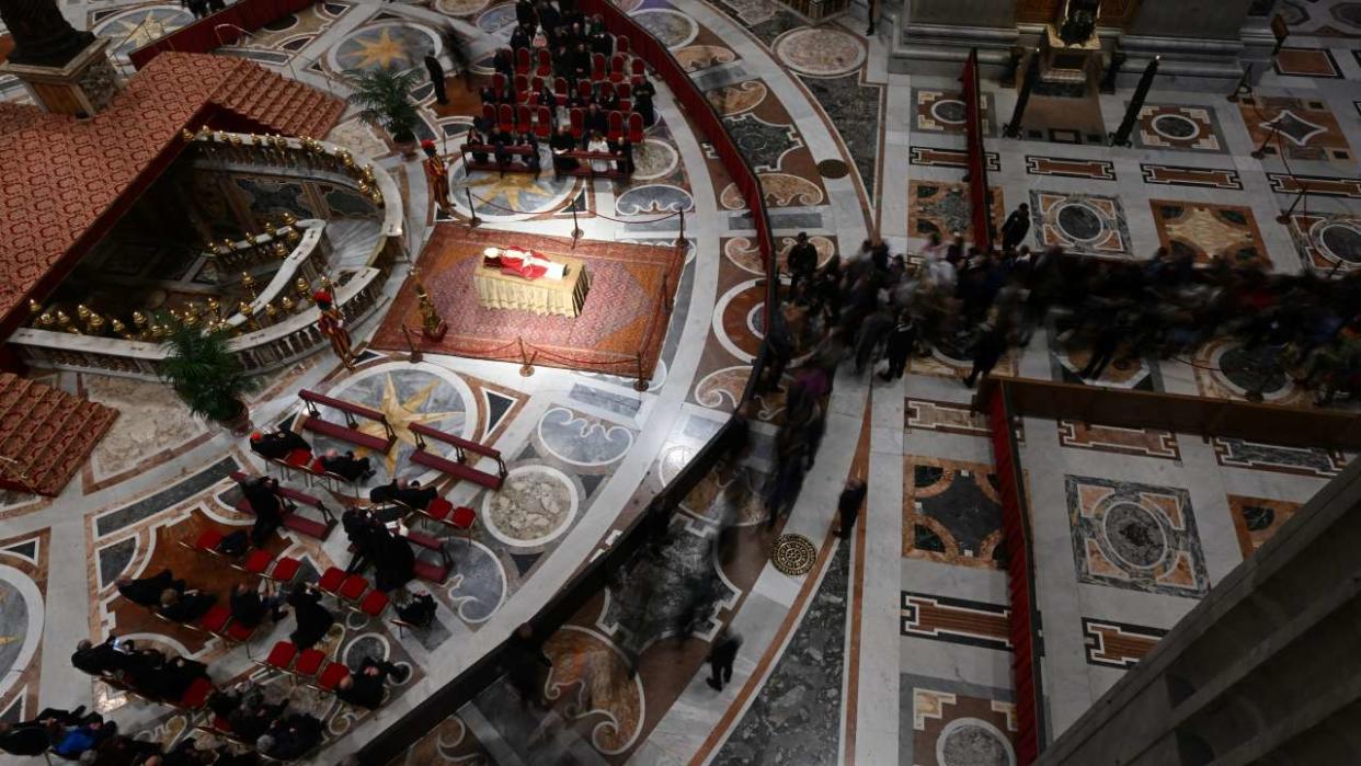 The body of Pope Emeritus Benedict XVI lies in state at St. Peter's Basilica in the Vatican, on January 3, 2023. - Benedict, a conservative intellectual who in 2013 became the first pontiff in six centuries to resign, died on December 31, 2022, at the age of 95. Thousands of Catholics began paying their respects on January 2, 2023 to former pope Benedict XVI at St Peter's Basilica at the Vatican, at the start of three days of lying-in-state before his funeral. (Photo by Filippo MONTEFORTE / AFP)