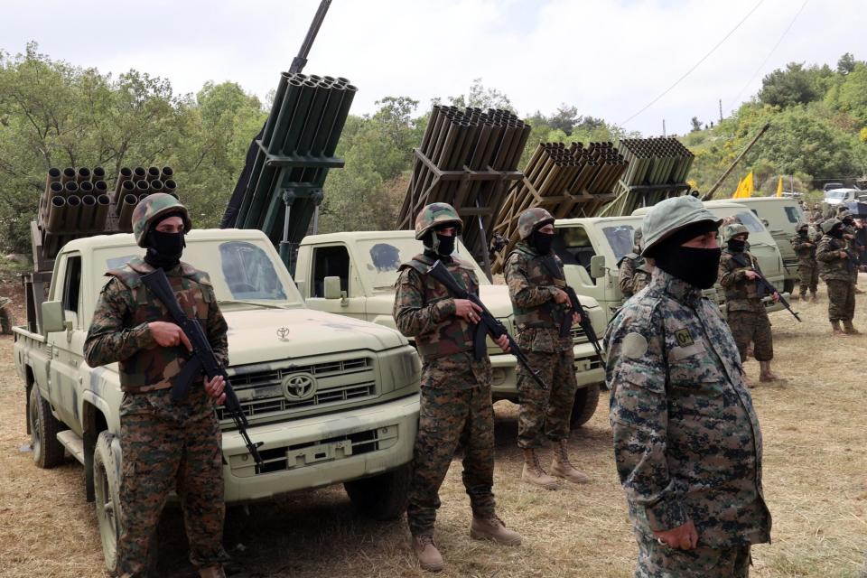 Lebanese Hezbollah fighters stand near multiple rocket launchers during a press tour in the southern Lebanese village of Aaramta, on May 21, 2023, ahead of the anniversary of the Israeli withdrawal from Lebanon. <em>Photo by ANWAR AMRO/AFP via Getty Images</em>