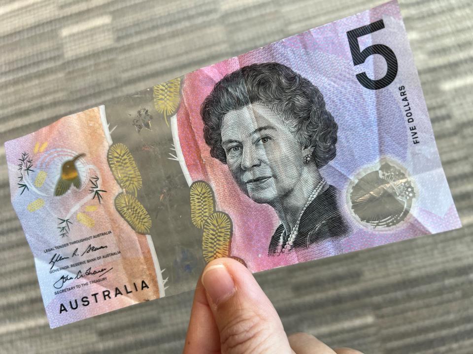This photo illustration taken in Hong Kong on February 2, 2023 shows the Australian $5 banknote. - Australia's central bank announced on February 2, 2023 it will erase the British monarch from its banknotes, replacing the late Queen Elizabeth II's image on its $5 note with a design honouring Indigenous culture. (Photo by Mladen ANTONOV / AFP) (Photo by MLADEN ANTONOV/AFP via Getty Images)