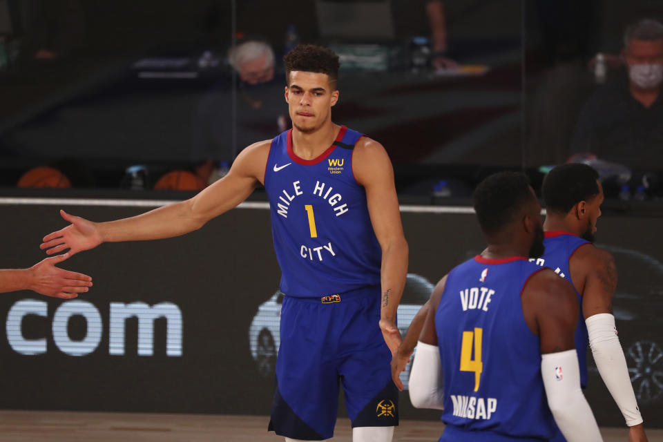 Denver Nuggets forward Michael Porter Jr. (1) is greeted by teammates during player introductions before the first half of an NBA basketball game Wednesday, Aug. 5, 2020, in Lake Buena Vista, Fla. (Kim Klement/Pool Photo via AP)