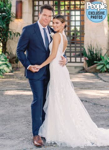 <p>Ashley Goodwin Photography</p> Dane Cook and Kelsi Taylor at their Sept. 23 wedding at a private estate in O’ahu, Hawaii.