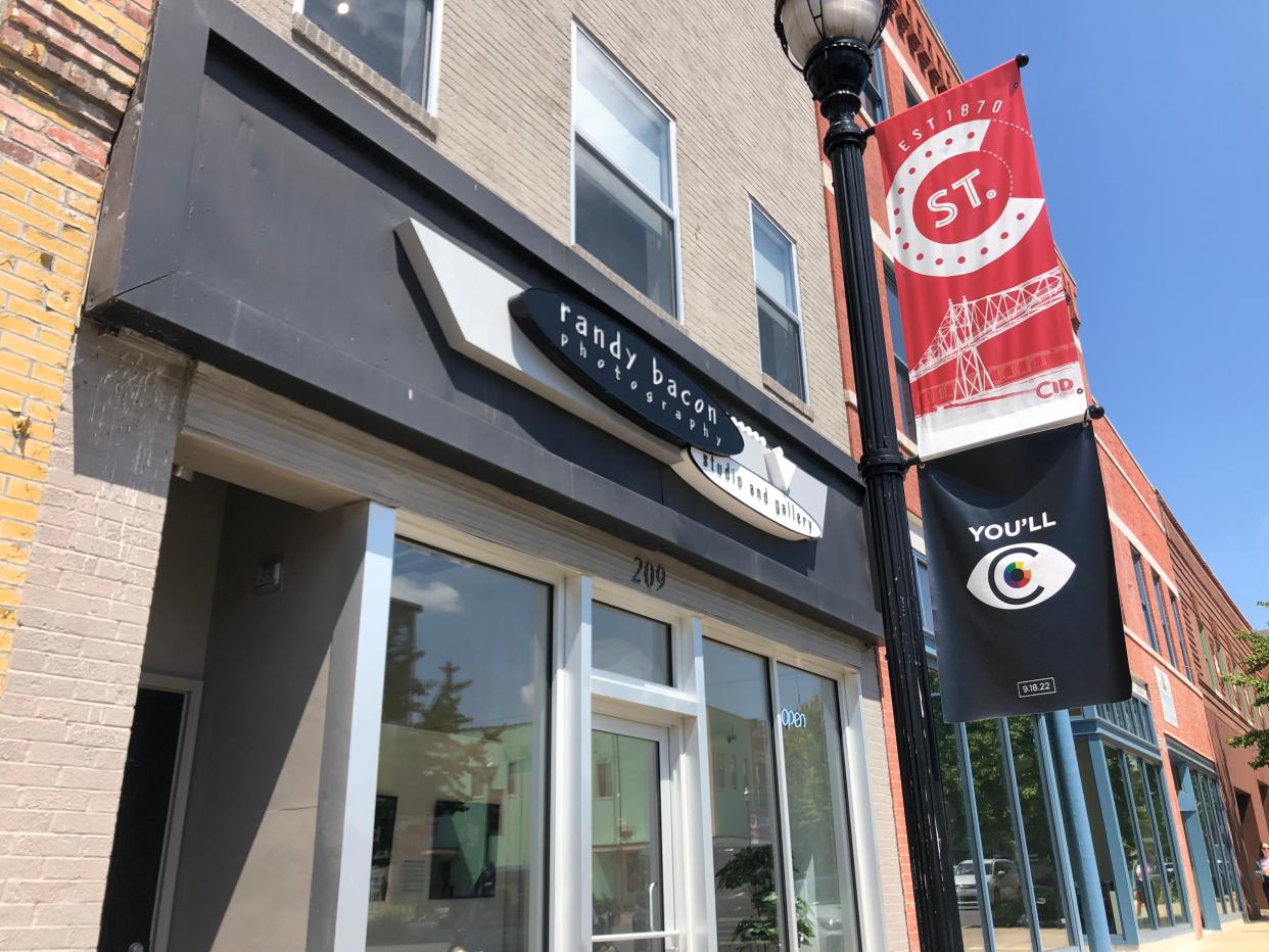 A black banner featuring an abstract eyeball and the date Sept. 17, 2022 hangs outside of Randy Bacon Photography Studio and Gallery on Commercial Street on Thursday, Aug. 25. The banner was a part of the "teaser" campaign for C-Art, a new, ongoing art event to take place along Commercial Street. The inaugural event is Sunday, Sept. 18 from 1-4 p.m.