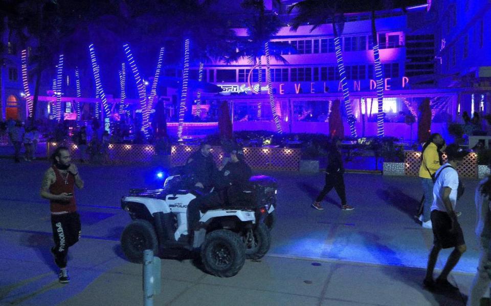 Miami Beach police officers are seen along Ocean Drive on Saturday, Feb. 20, 2021.