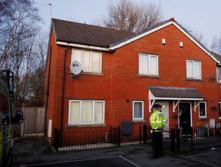 Police officers stand outside a house being searched in connection to a stabbing at Victoria Station in Manchester, Britain, January 1, 2019. REUTERS/Phil Noble