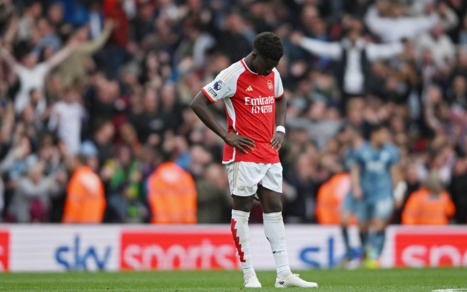 Bukayo Saka bows his head as Aston Villa fans celebrate their killer second goal behind him