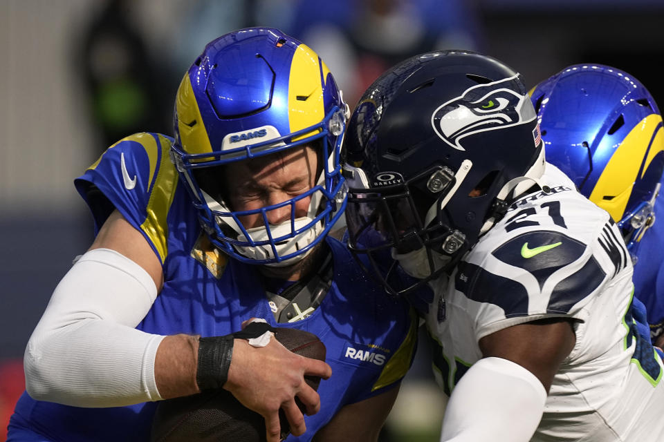 Seattle Seahawks cornerback Devon Witherspoon (21) sacks Los Angeles Rams quarterback Matthew Stafford (9) during the first half of an NFL football game Sunday, Nov. 19, 2023, in Inglewood, Calif. (AP Photo/Mark J. Terrill)